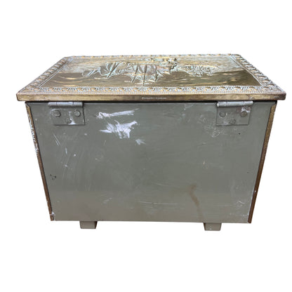 Edge detail of brass lid showing wear and rubbed finish on a decorative chest