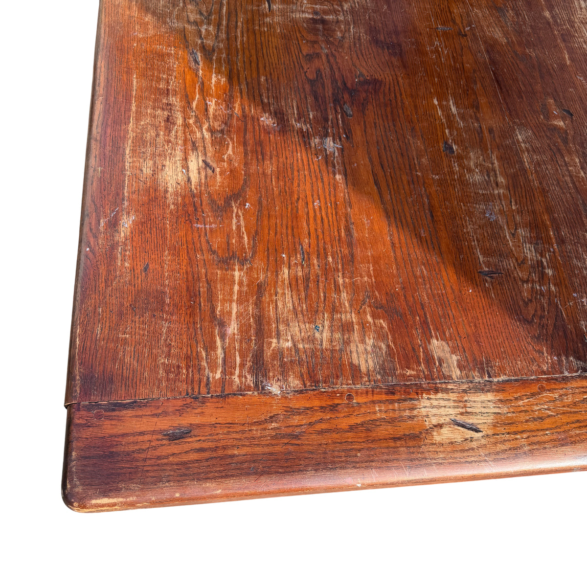 End view of heavy oak trestle dining table with large turned legs