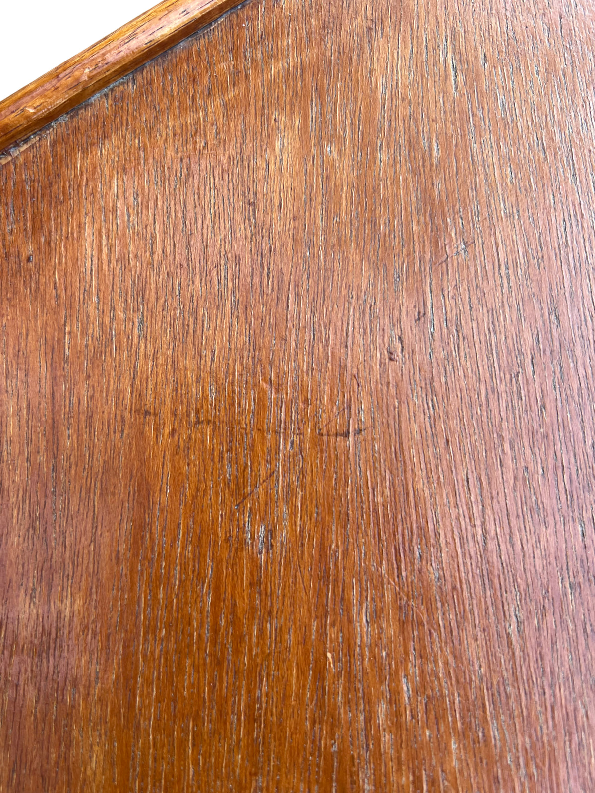 Wooden hexagon occasional table showing scratches and finish wear