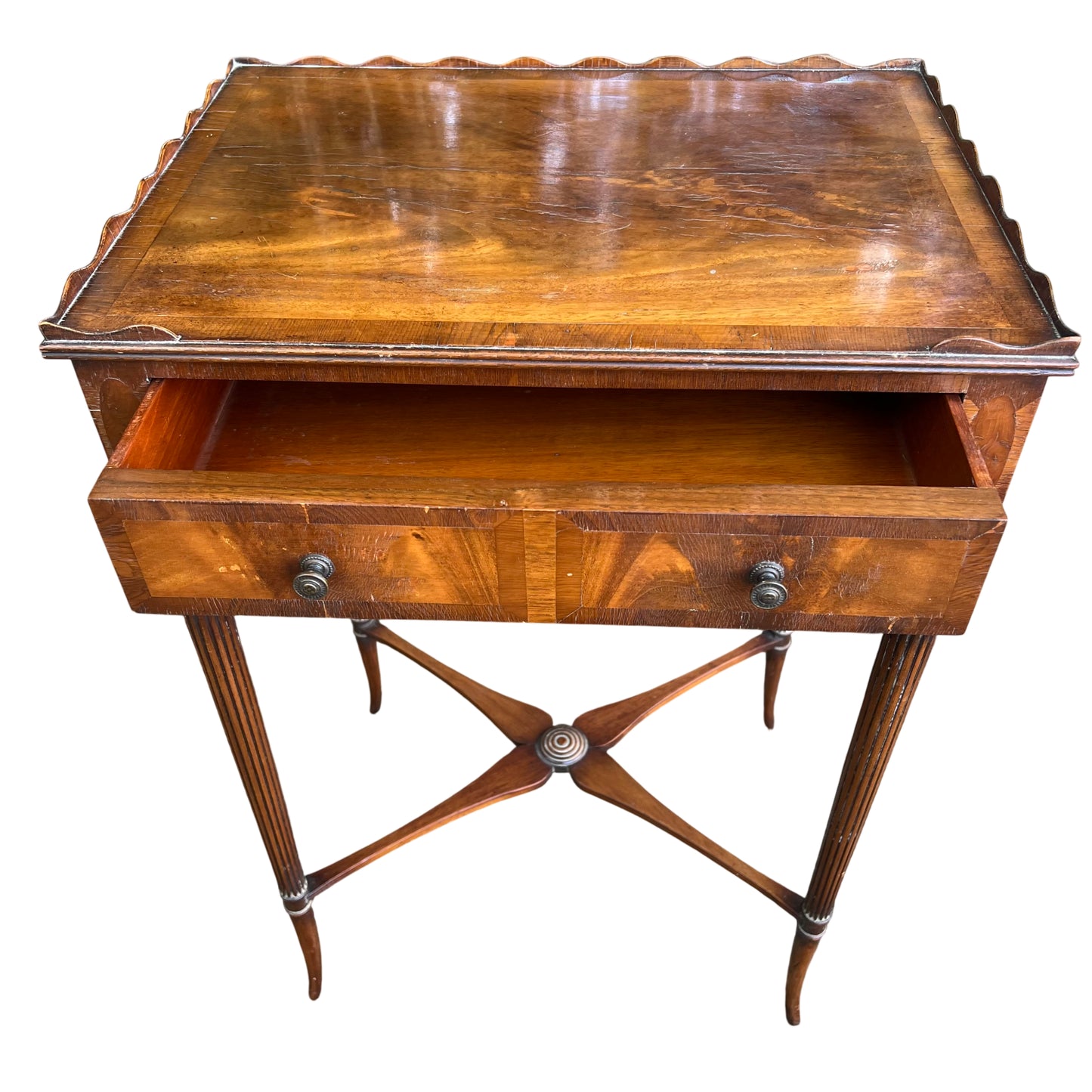 Top view of walnut veneer table showing scalloped gallery edge