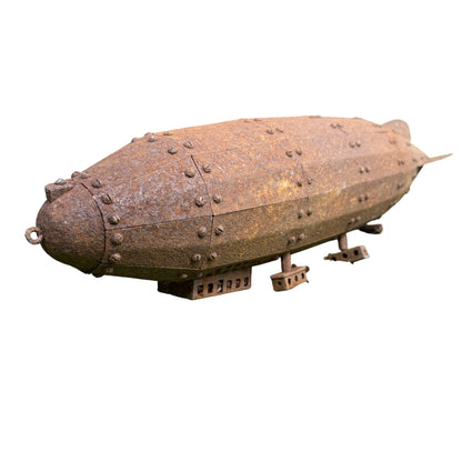 Underside fittings and small articulated bracket on the rusted pressed-steel model airship