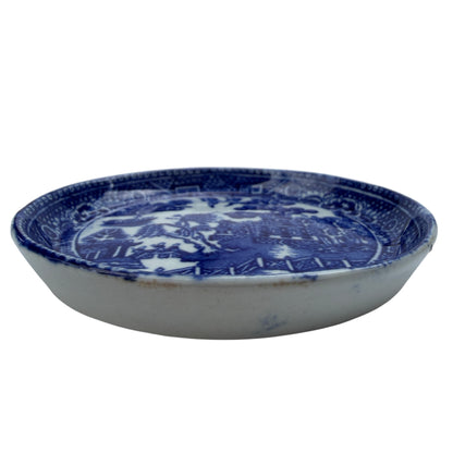 Underside view of small blue and white Staffordshire butter pat
