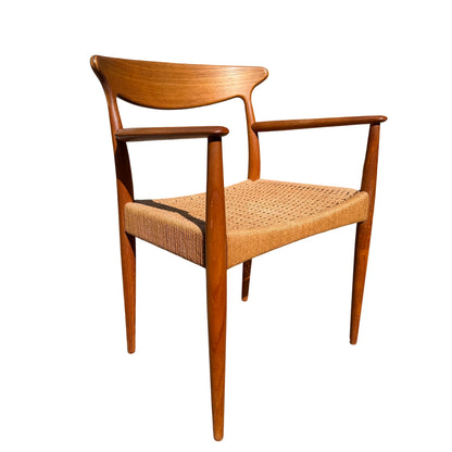 Side view of teak armrest and turned back support on Danish modern dining chair