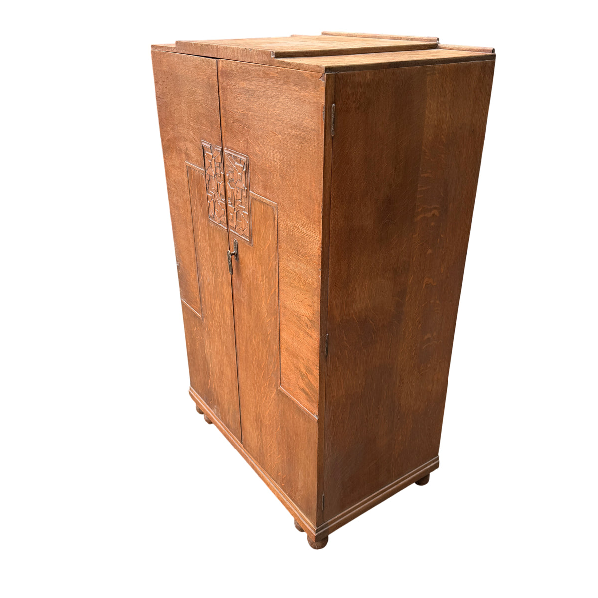 Side view oak linen cupboard showing panelled sides and bun feet