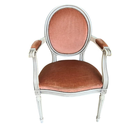 Vintage Louis XVI style upholstered armchair in peach velvet with painted wooden frame and brass nailhead trim