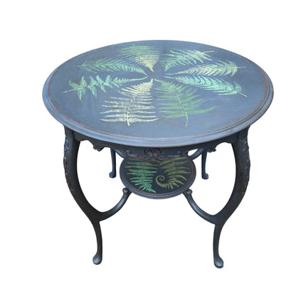 Vintage painted round side table with hand-painted fern motifs and carved apron in dark wax finish