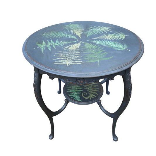 Vintage painted round side table with hand-painted fern motifs and carved apron in dark wax finish
