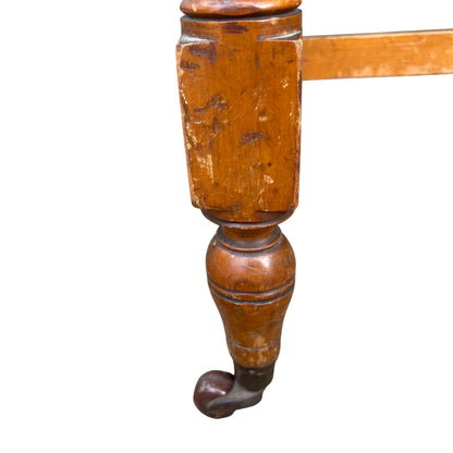 Underside view showing stretcher joinery between turned legs