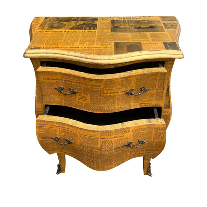 Close-up of gilt moulded top and newspaper decoupage surface on bedside cabinet