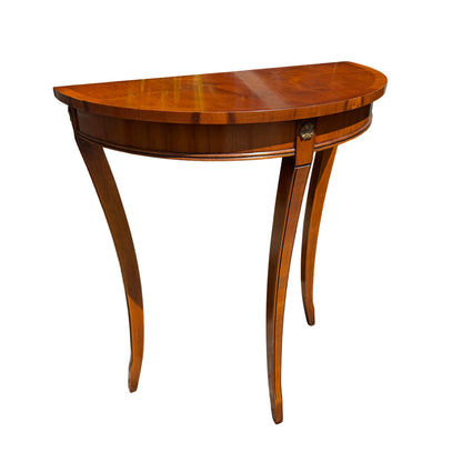 Mahogany demi-lune console table with veneered half-moon top and slender tapered legs