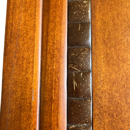 Pair of turned wooden knobs on the lower cupboard doors of oak cabinet