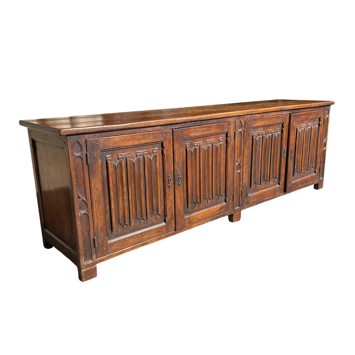 Carved oak sideboard with solid top and vertical tracery panels in Gothic style