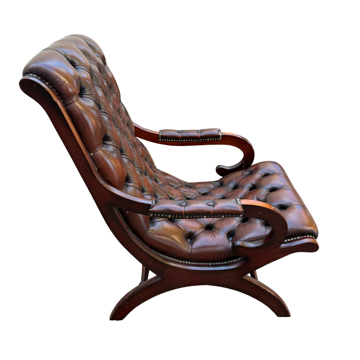 Side view showing curved mahogany arm and studded leather arm pad