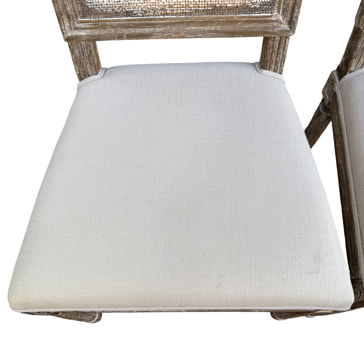 Distressed whitewashed wooden leg and carved detail on dining chair