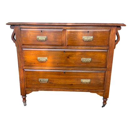 Victorian oak chest of drawers two short over three long with brass drop handles and turned legs on castors