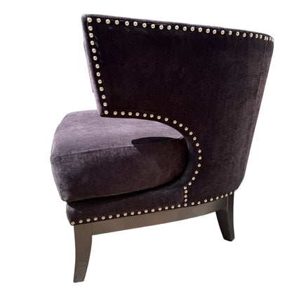 Chair leg and lower frame of black armchair showing painted timber leg and studded edge