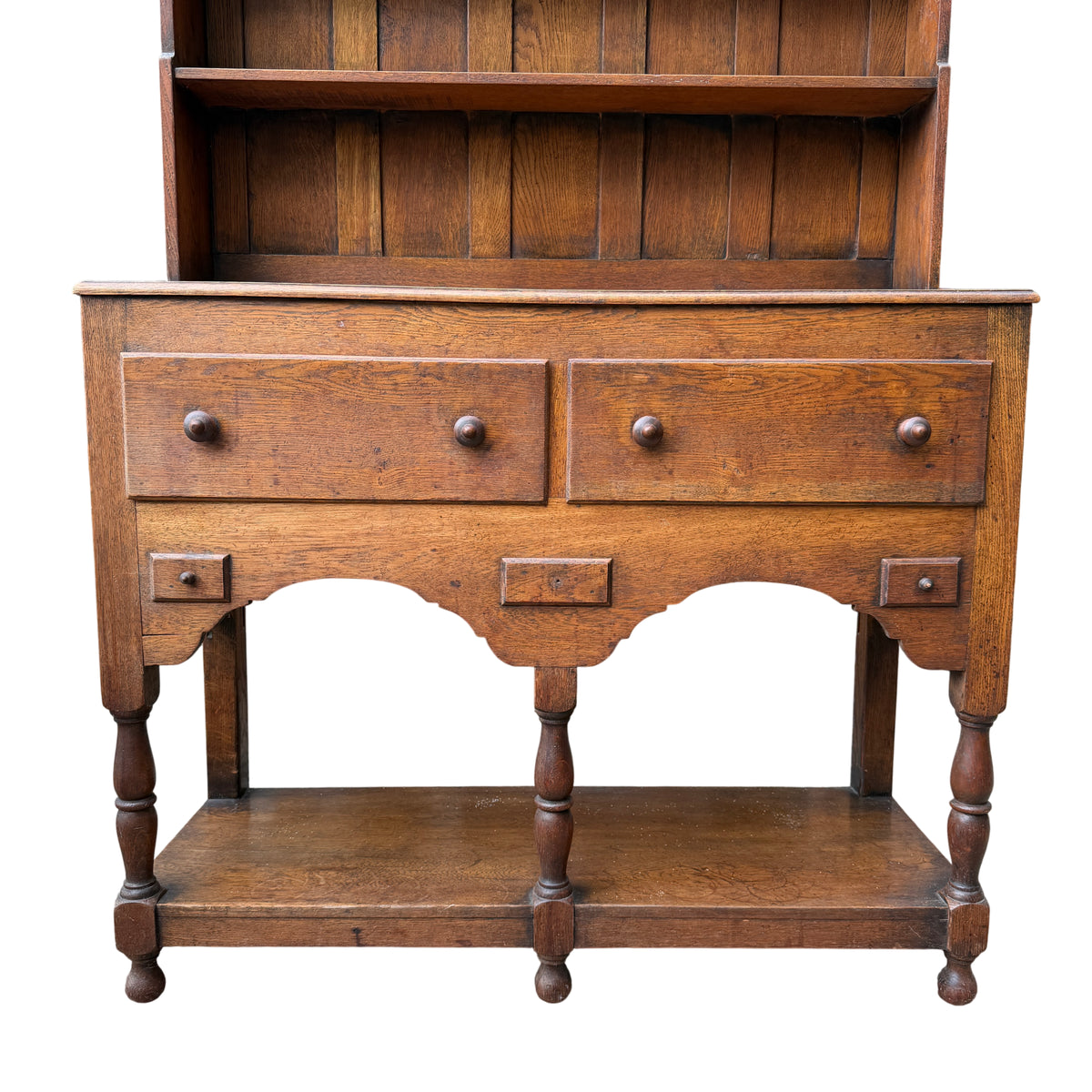 Close up of oak dresser showing two larger drawers with round wooden knobs
