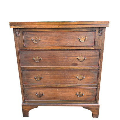 Close-up of brass drop handles on an oak chest of drawers