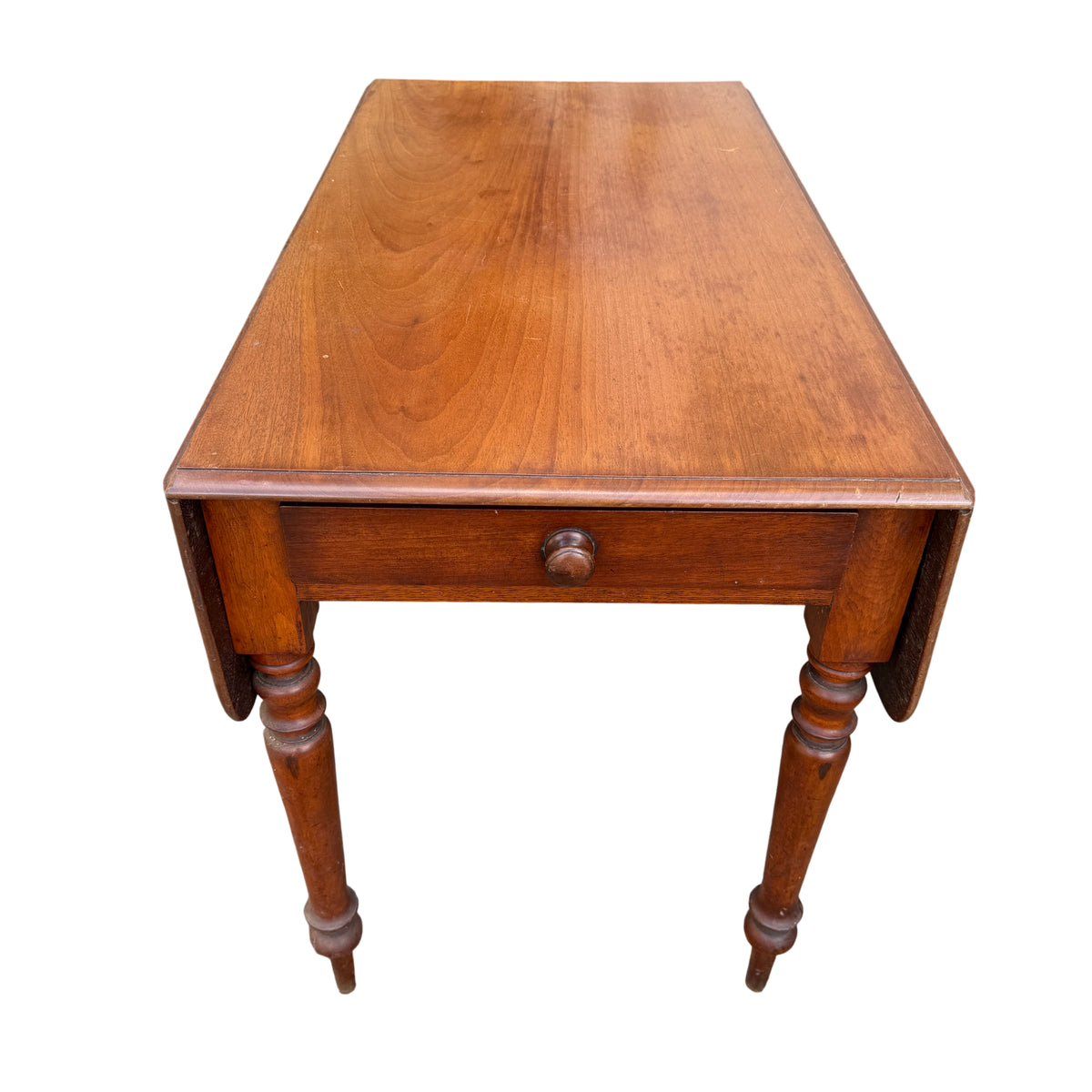 View of table top showing warm wood grain and panelled folding leaves