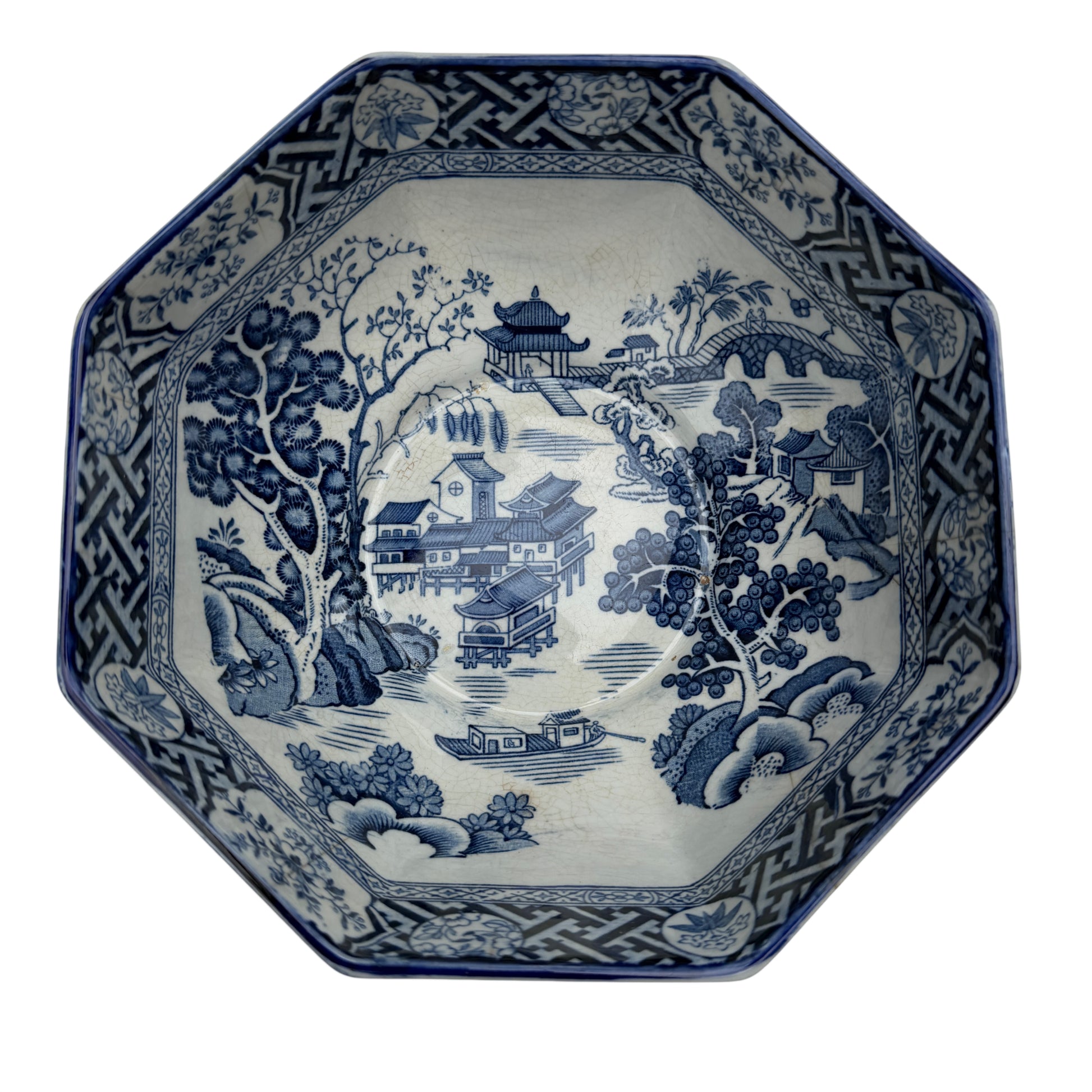 Close view of octagonal rim and decorative transferware border on porcelain bowl