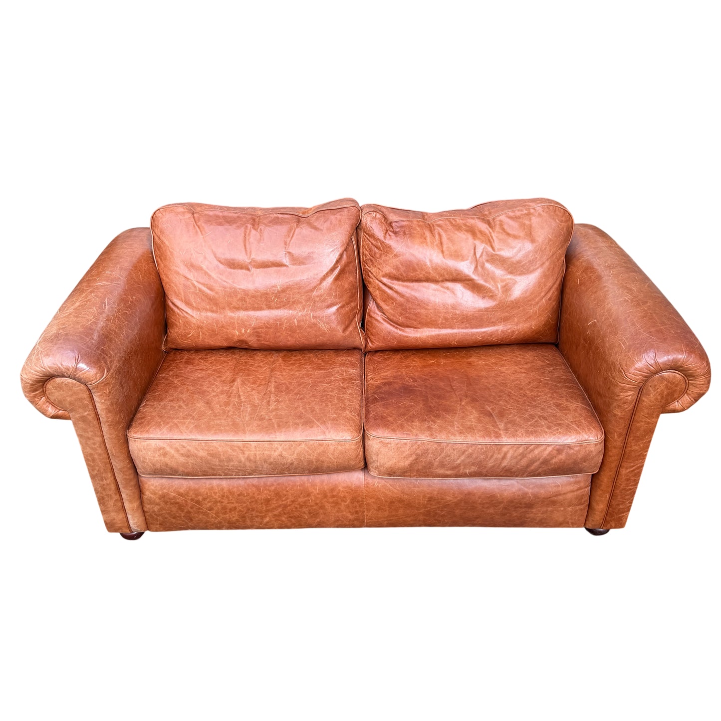 Close-up of cognac tan leather arm and rolled arm detail on two-seater sofa
