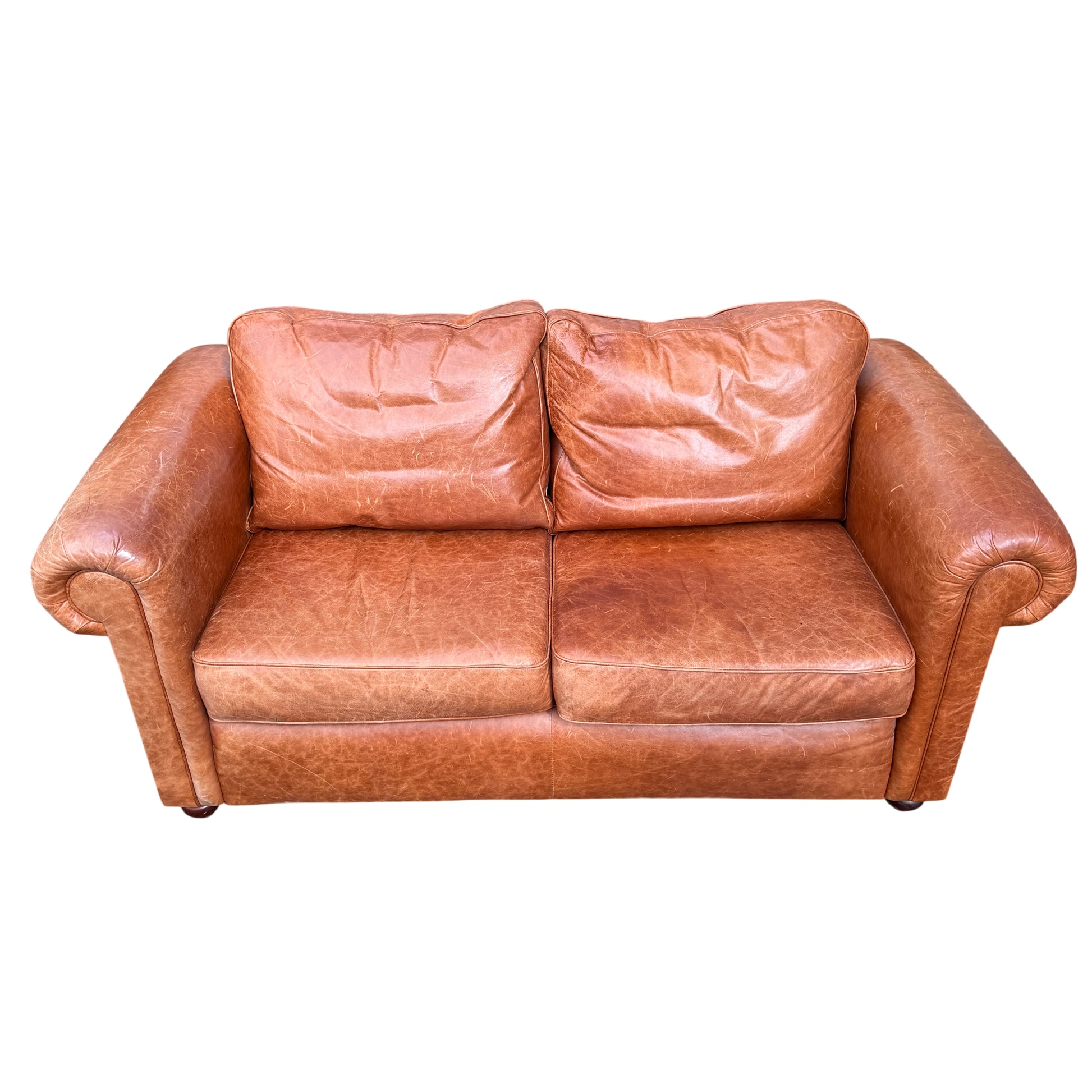 Close-up of cognac tan leather arm and rolled arm detail on two-seater sofa