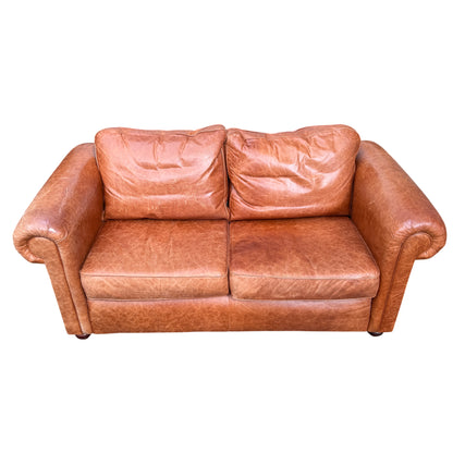Close-up of cognac tan leather arm and rolled arm detail on two-seater sofa