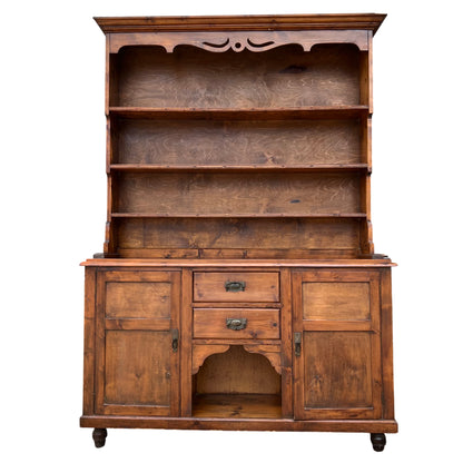 Open hutch-style pine dresser with turned feet and brass handles