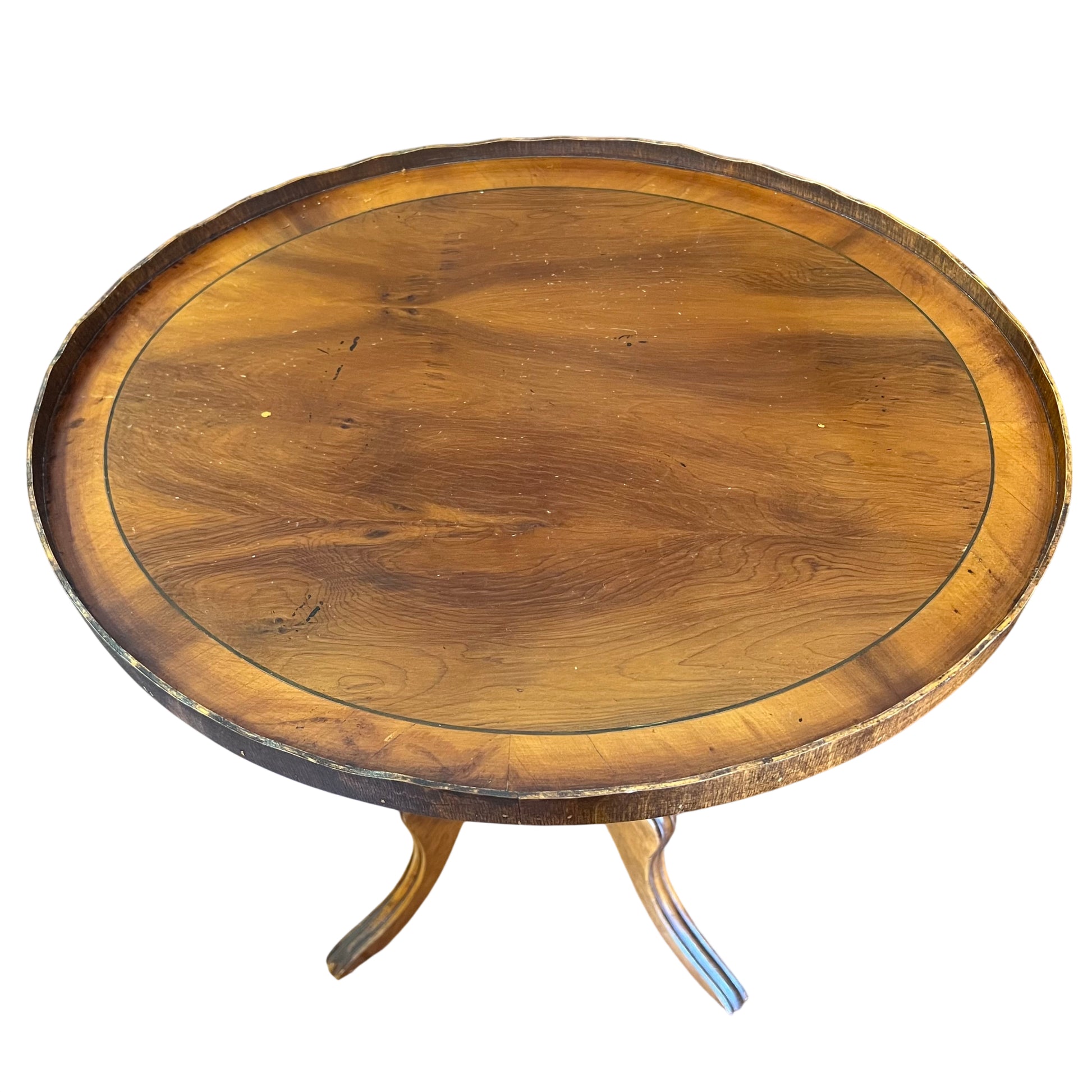 Close view of walnut circular top with galleried rim and visible wood grain