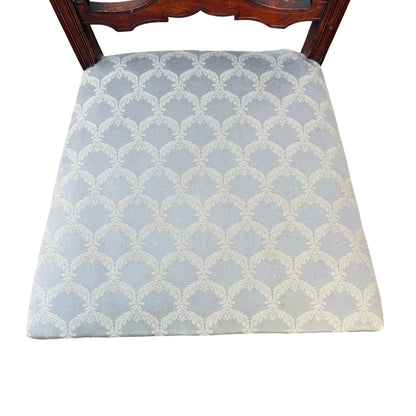 Grey patterned upholstered seat on antique mahogany dining chair, front perspective