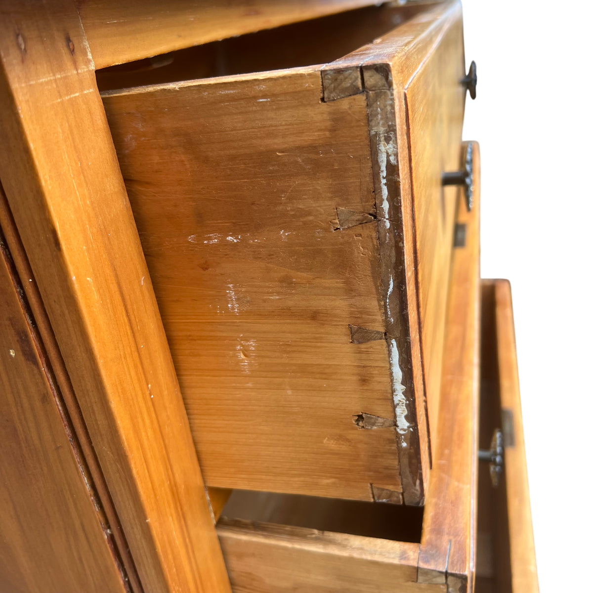 Detail of scalloped bracket base on pine tallboy chest