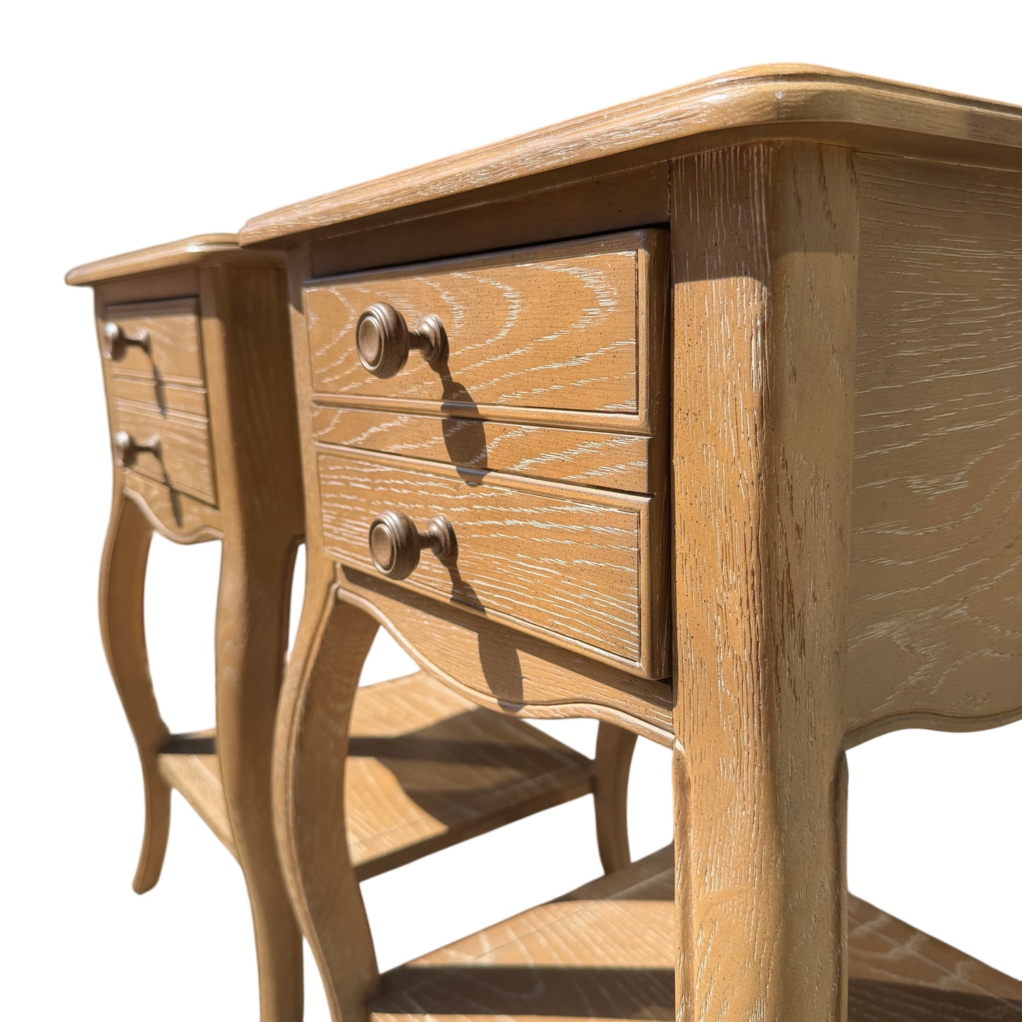Close-up of drawer front and round knob on oak-effect bedside cabinet