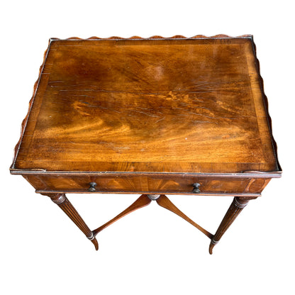 Narrow walnut occasional table with fluted turned legs and cross stretcher
