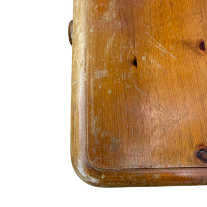 Side view of solid pine chest showing rounded top edge and plinth base
