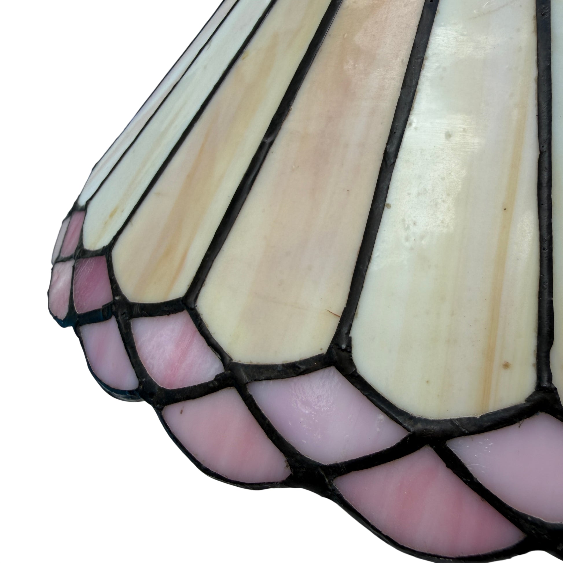 Underside of stained glass lamp showing black metal gallery and central finial with decorative detailing