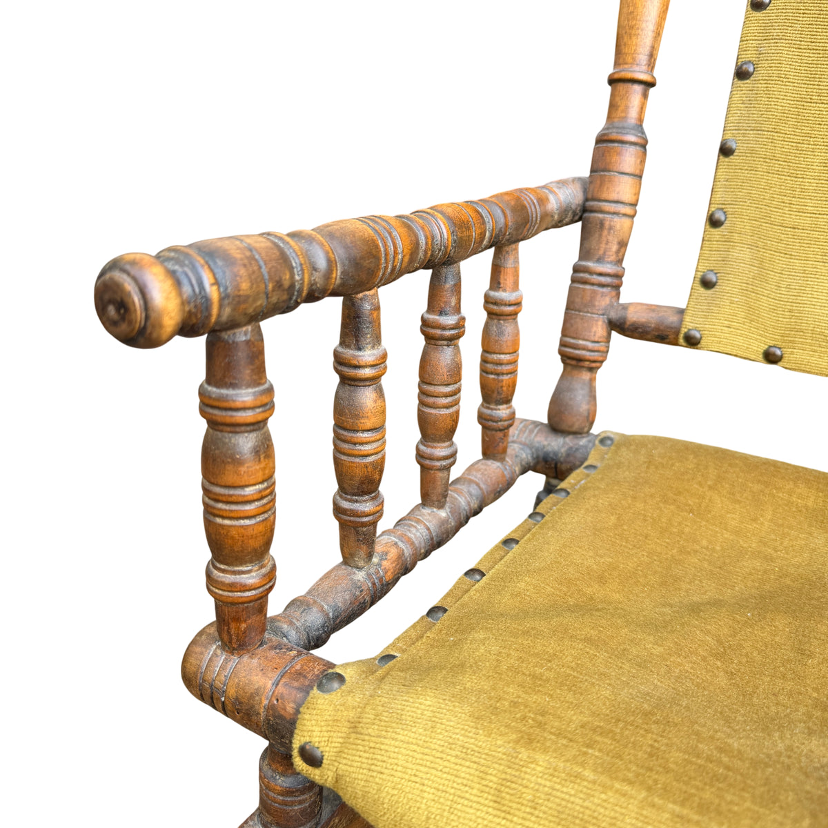 Top view of upholstered back pad with decorative tacks on a child's rocking chair