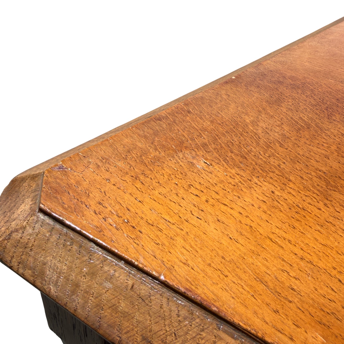 View down the length of oak chair seat showing surface wear and scratches
