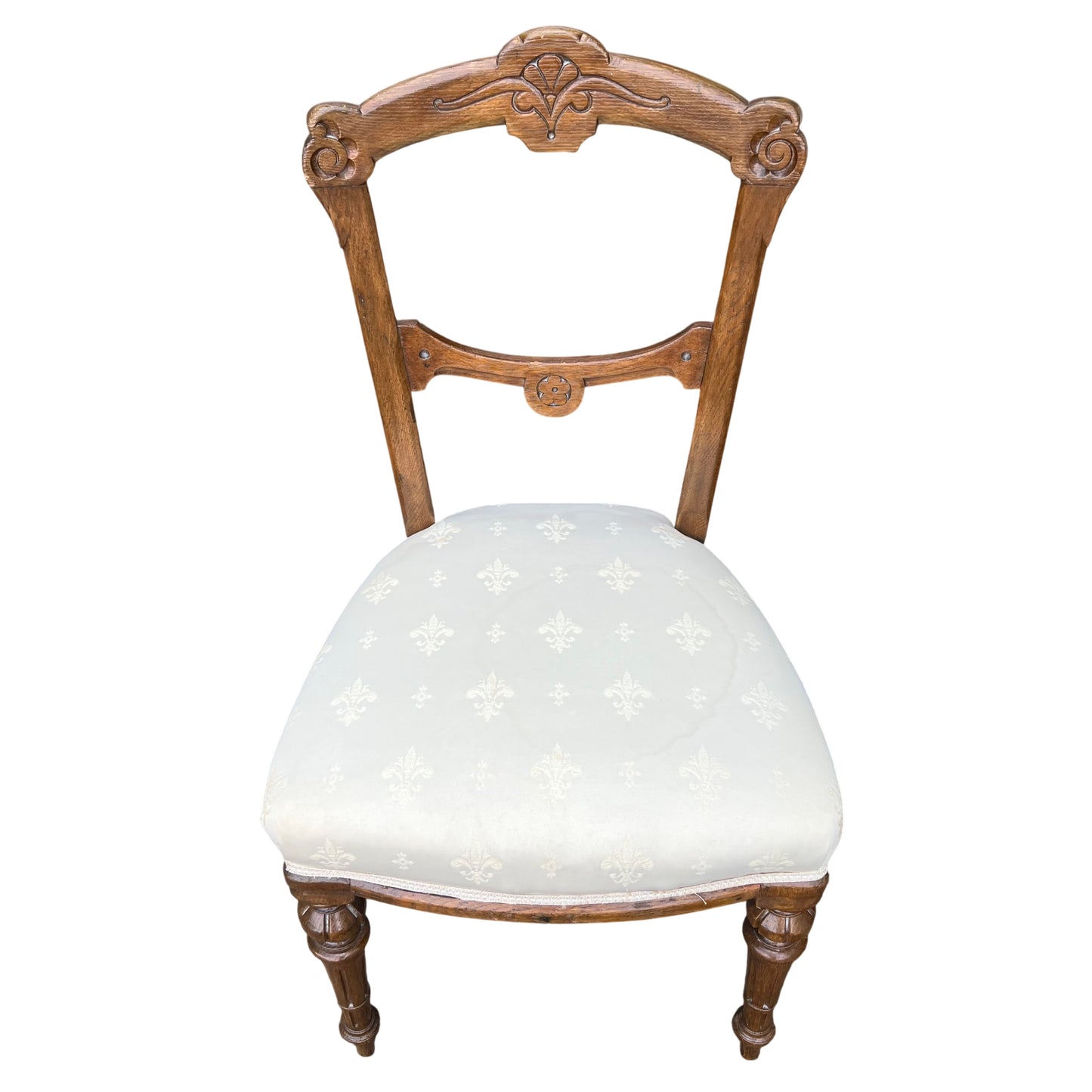 Victorian oak dining chair with carved decorative top rail and cream upholstered seat