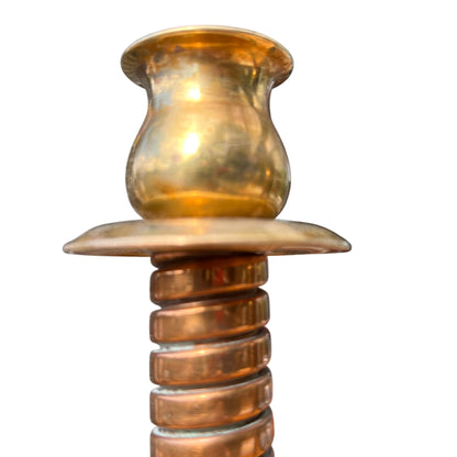 Top view of brass candlestick sockets and drip trays on a matching pair