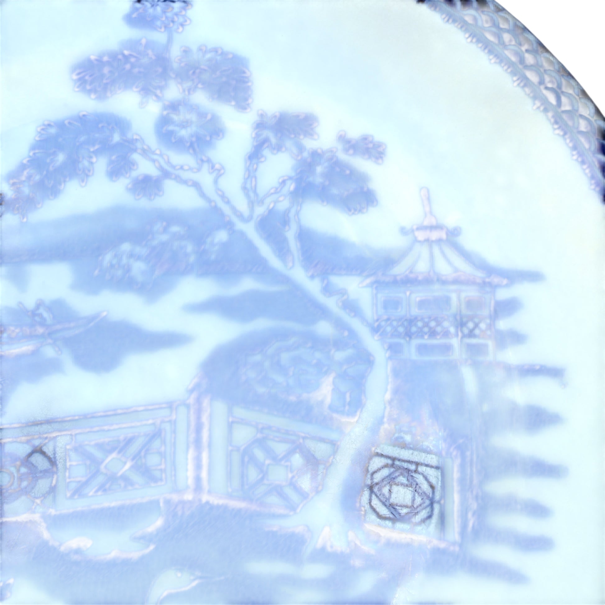 Full view of the blue transferware plate laid flat showing oriental pattern