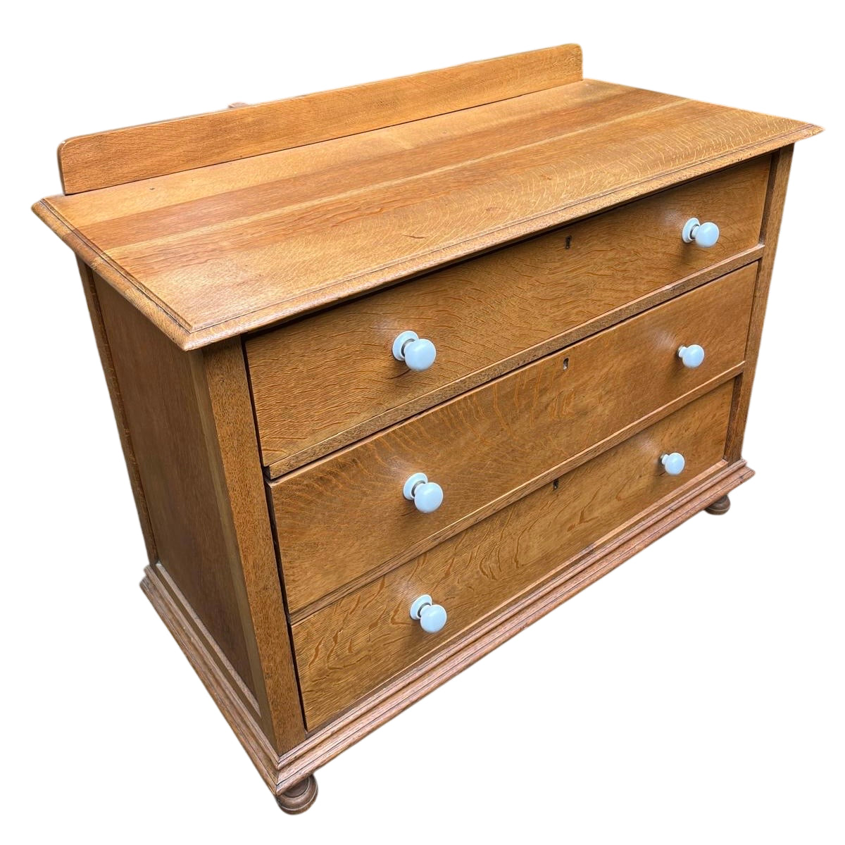 Top view showing moulded oak top and small upstand of a 3-drawer chest