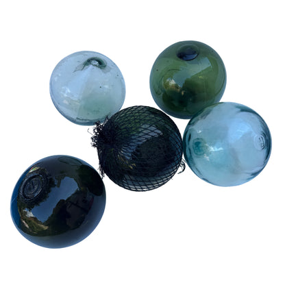 Vintage hand-blown glass float in pale aqua with pontil mark and surface bubbles