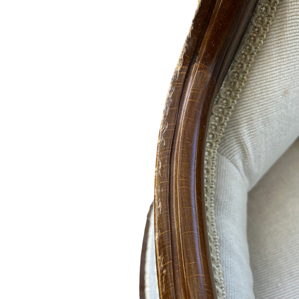 Carved cabriole front leg and wooden base of Victorian armchair