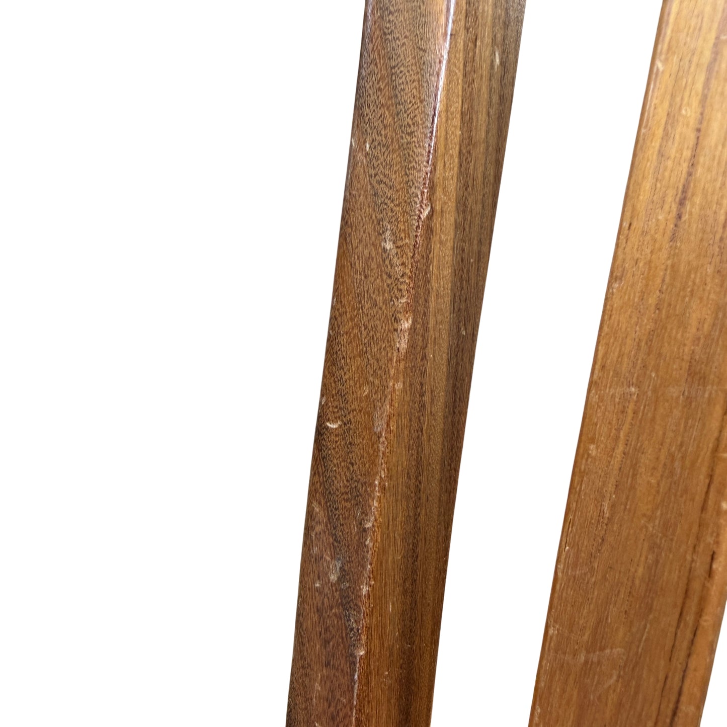Group of four vintage dining chairs arranged outdoors against a wooden backdrop