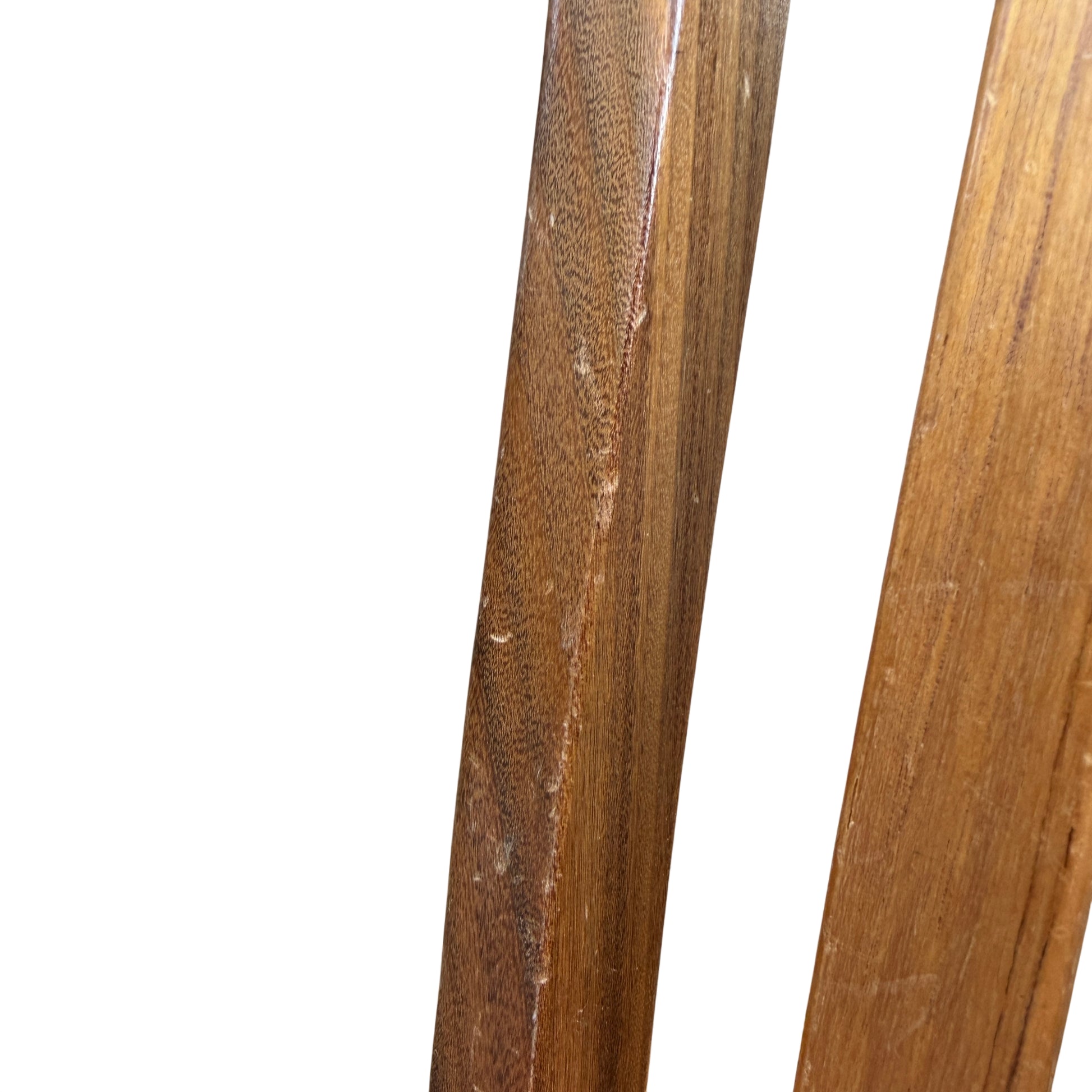 Group of four vintage dining chairs arranged outdoors against a wooden backdrop