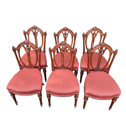 Close up of red and gold striped upholstery on a Victorian dining chair seat