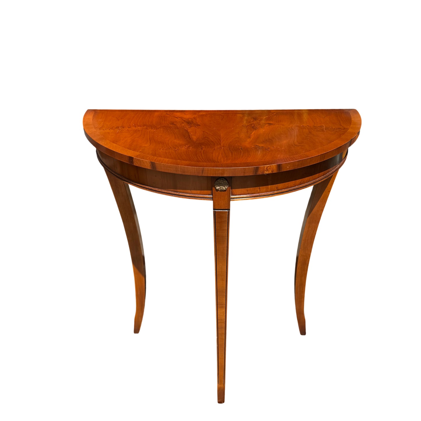 Close up of demi-lune table top with book-matched mahogany veneer and curved edge