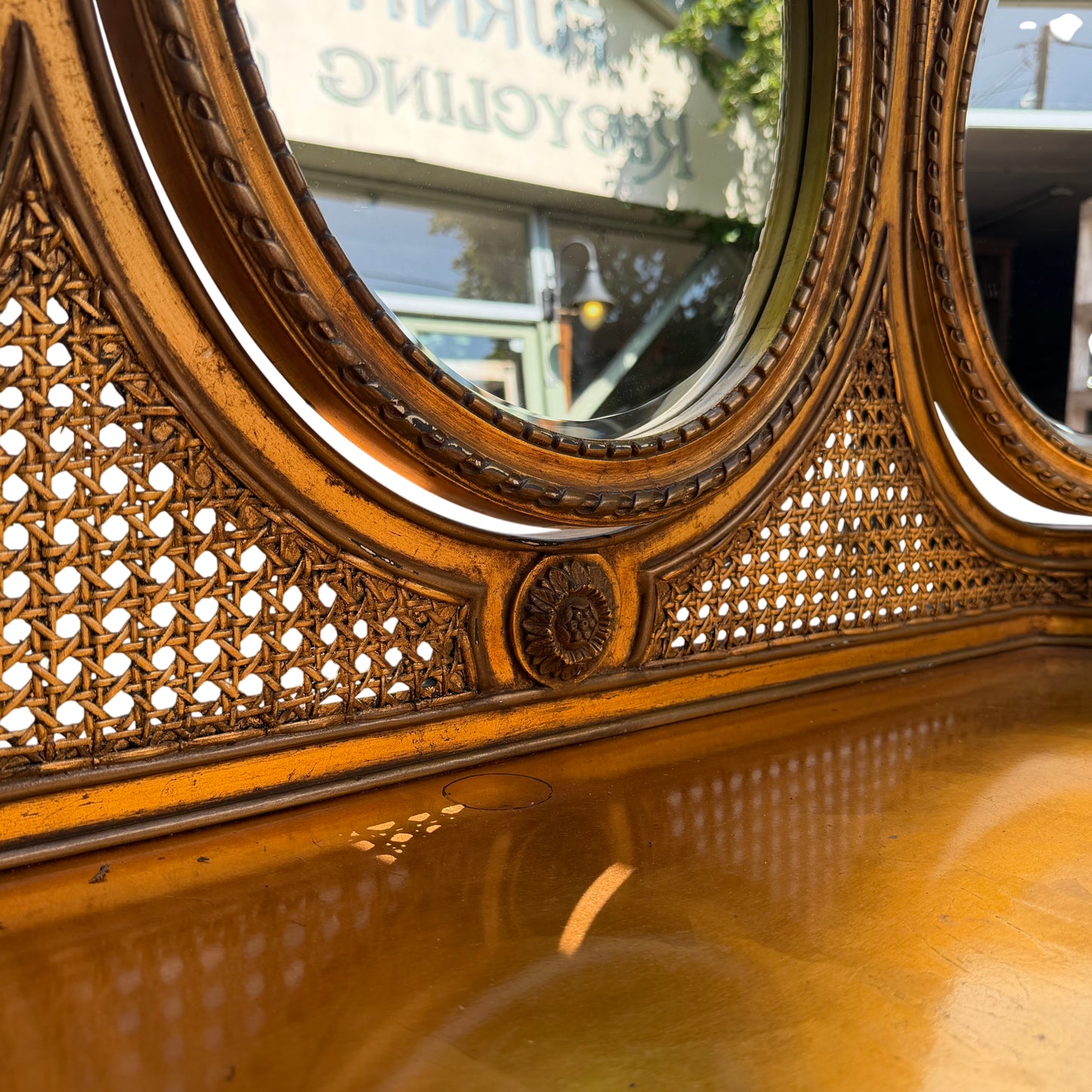 Close up of woven or carved decorative panel beneath the mirrors