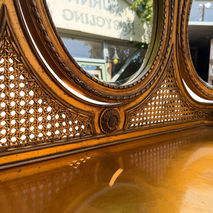 Close up of woven or carved decorative panel beneath the mirrors