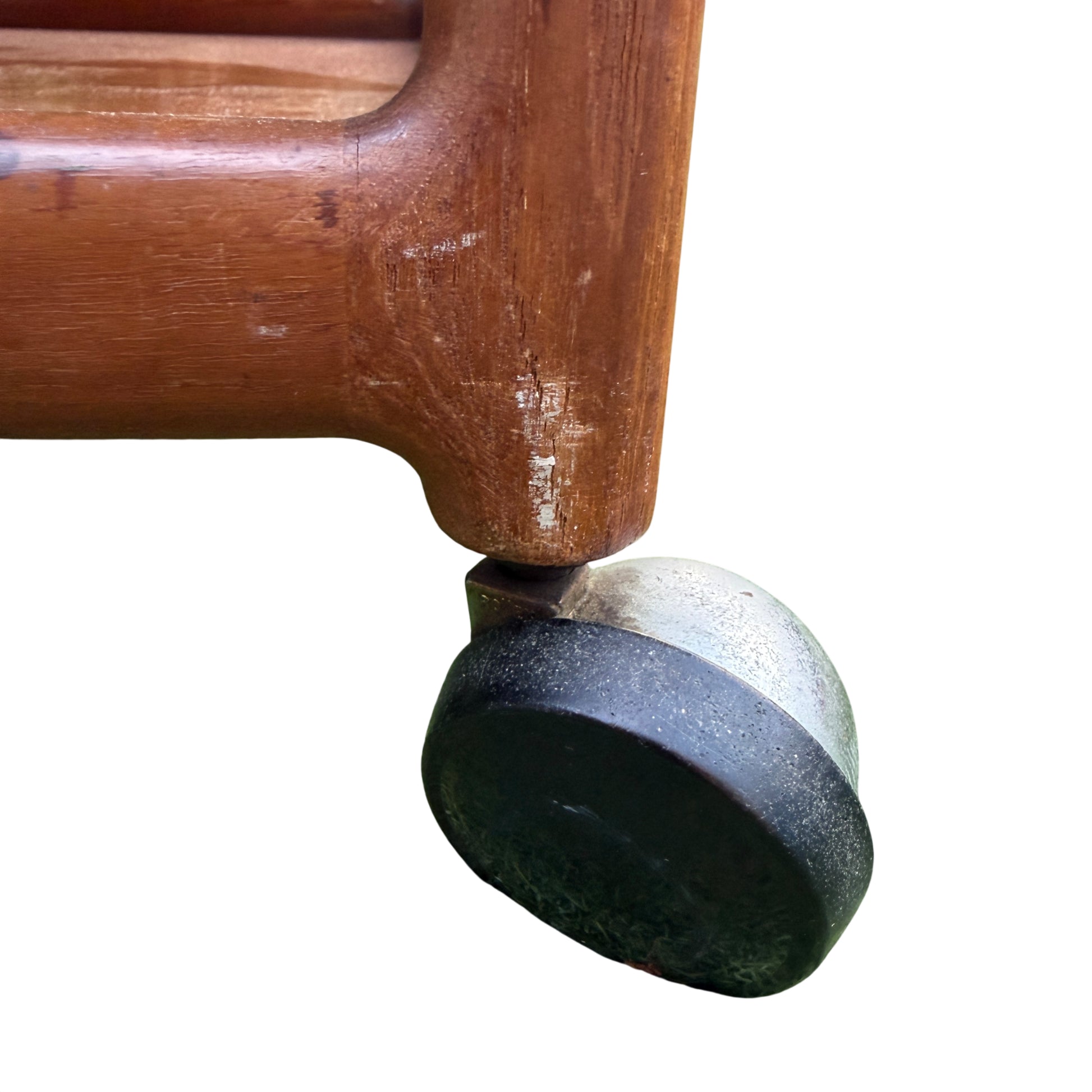 Lower wooden shelf and castor wheel on a vintage teak trolley